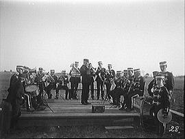 [Wolfe Island Band Performing on a Wooden Stage in a Field]